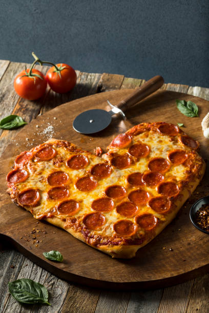 istock Homemade Heart Shaped Pepperoni Pizza 641501438