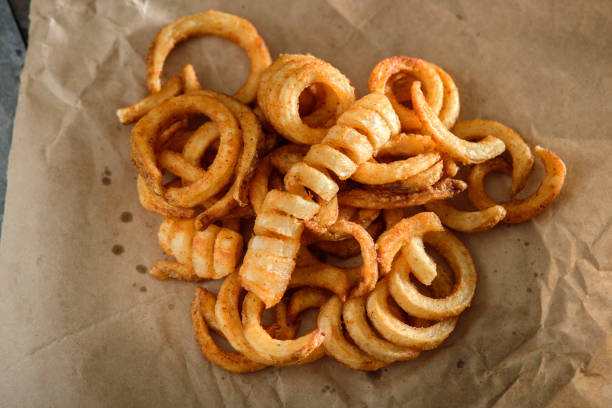 Curly Fries Delicious Fried Curly Fries close up curly fries stock pictures, royalty-free photos & images