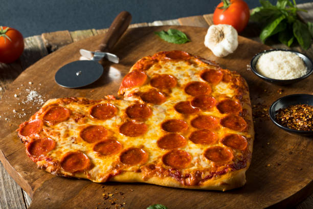 istock Homemade Heart Shaped Pepperoni Pizza 641502124