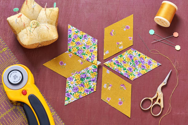 istock Design of  element quilt in progress, prepared cut pieces around accessories, top view 641502132