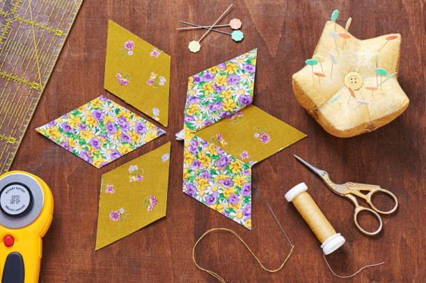 istock Design of  element quilt in progress, prepared cut pieces around accessories, top view 641502142