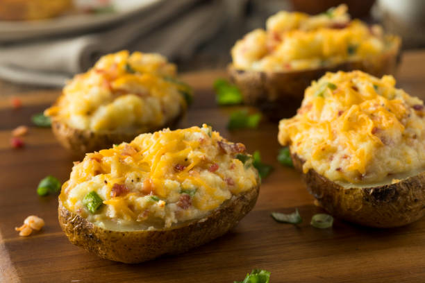 Homemade Twice Baked Potatoes Homemade Twice Baked Potatoes with Bacon and Cheese halved photos stock pictures, royalty-free photos & images