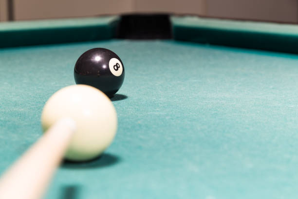 istock Cue aiming black ball into snooker billards table pocket 641503446