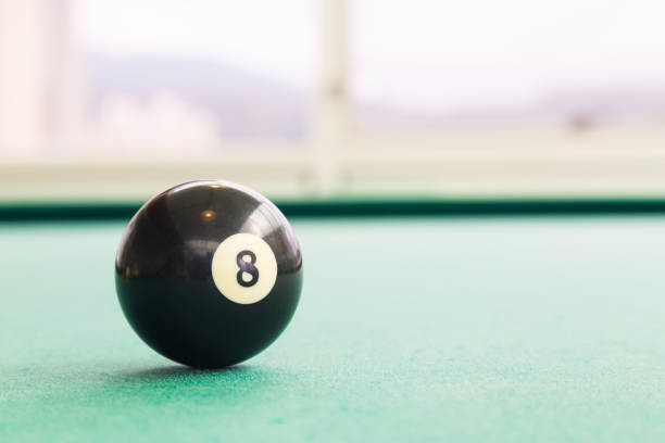 istock Closeup black snooker billards ball on table with green surface 641503844