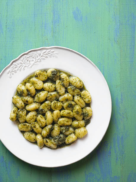 istock rustic italian gnocchi in pesto sauce 641504032
