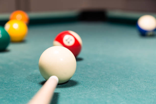 istock Cue aiming red ball into snooker billards table pocket 641504090