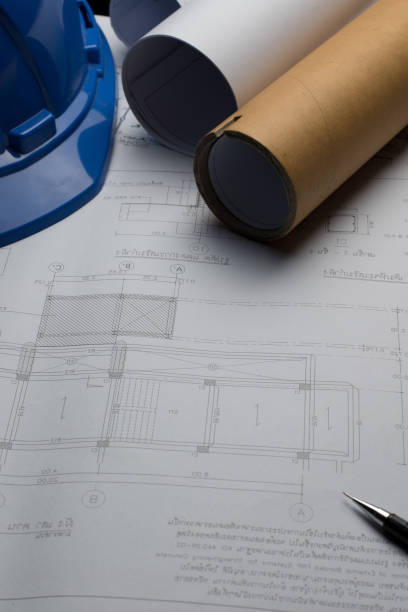 istock Architectural blueprints and blueprint rolls and a drawing instruments on the worktable. 641505552
