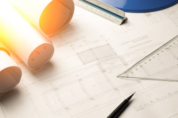istock Architectural blueprints and blueprint rolls and a drawing instruments on the worktable. 641505610