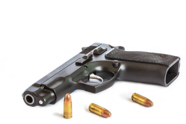 istock automatic pistol handgun with bullets isolated on white background 641507316