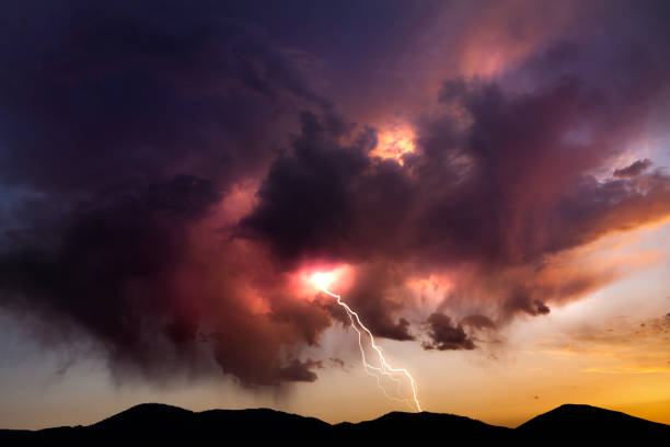 istock Lighting bolt striking from colorful clouds at sunset in the Nevada desert 641510614