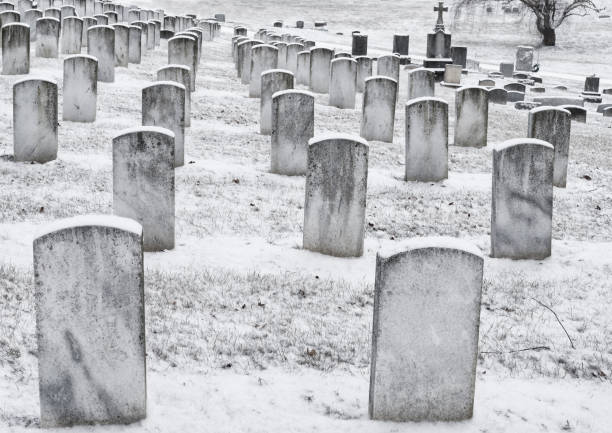 istock snowy headstones in a cemetery 641512168