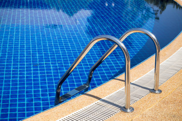 istock swimming pool with pool ladder in hotel 641512918