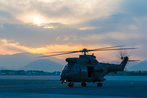 British Royal Army Puma military helicopter taxiing at dusk