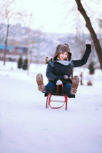 istock Charming Redheaded Woman Waving From Sledge Ride Outdoor 641516230