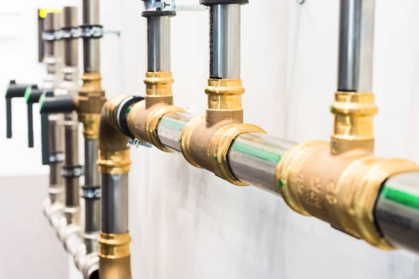 istock The metal pipes connected by brass tees. 641517126