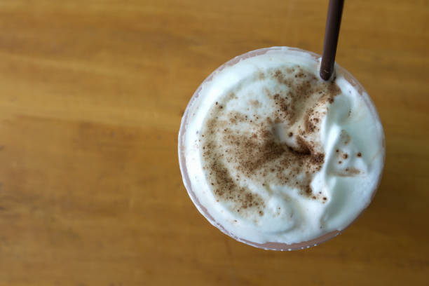 istock Milk foam and chocolate powder topping on ice coffee. 641520412