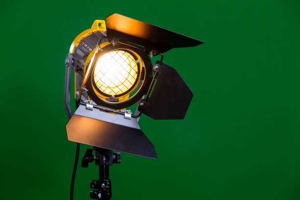 istock Halogen spotlight with a Fresnel lens on green background close-up 641521892