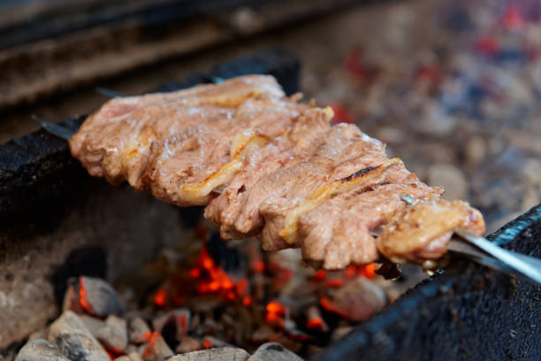 Spit roasted lamb meat on charcoal grill in a restaurant