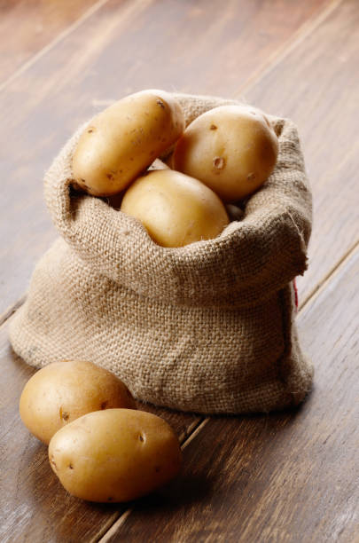 pomme de terre dans le sac - raw potato organic rustic bag photos et images de collection