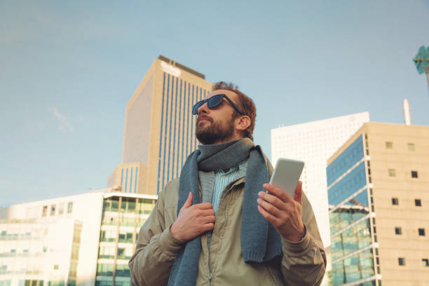 istock Modern guy using smartphone in the European city. 641532148