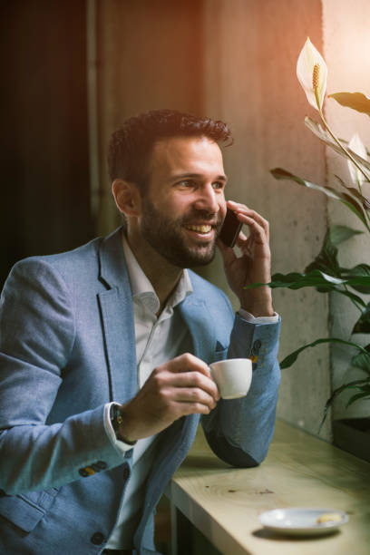 istock Businessman using smart phone in cafe 641535436