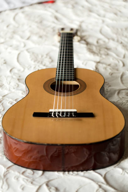istock Spanish guitar lying on the bed 641536980