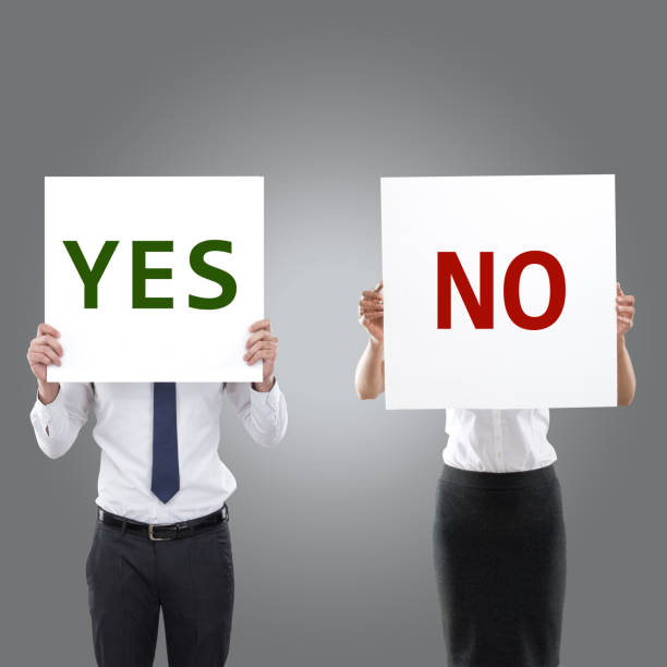 Business people holding yes and no placards