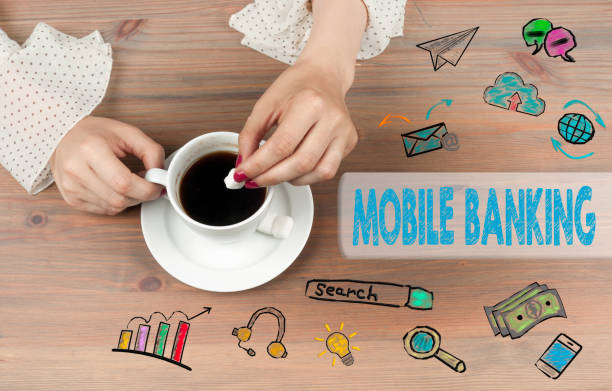istock Mobile banking. Coffee cup top view on wooden table background 641545308