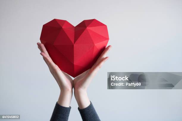 Female Hands Holding Red Polygonal Heart Shape Stock Photo - Download Image Now - Heart Shape, Passion, Concepts