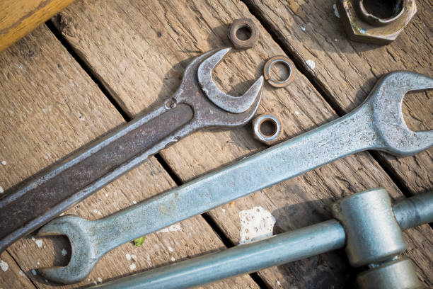 istock On weathered old wooden surface lie the , oily wrenches. 641546664