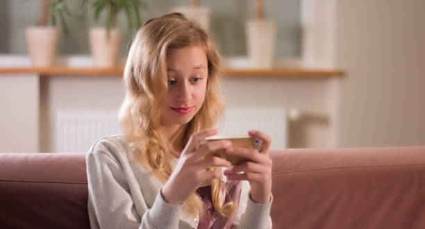 istock Young girl focus on smartphone screen, online surfing internet 641548202