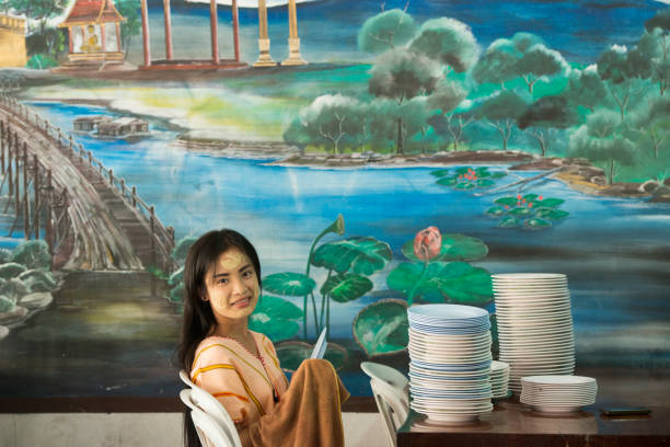 a women works in a restaurant in the Village of Thong Pha Phum north of the City of Kanchanaburi in Central Thailand in Southeastasia.