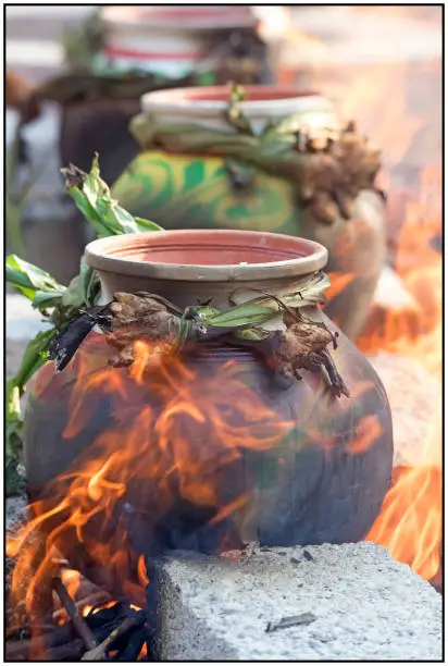 An ancient tradition of the Tamils (an ancient race) which honors the farmers by cooking Rice in decorated clay pots