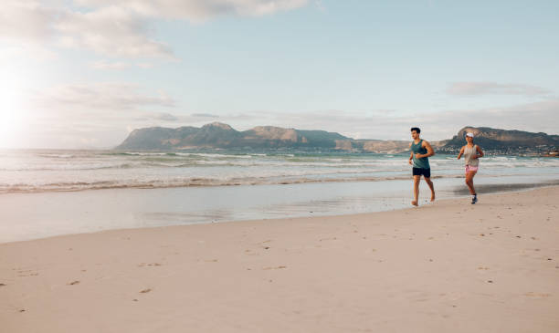 istock Couple on morning run at the beach 641552348