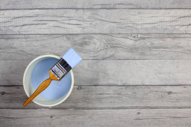 istock Paintbrush on a pot of light blue paint 641553440
