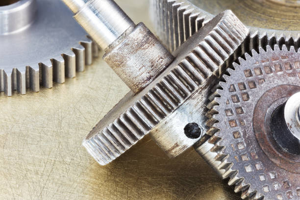 istock metal gearwheels and machinery details on scratched background 641559430