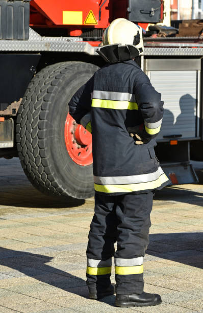 istock Firefighter stands next to a vehicle 641561980