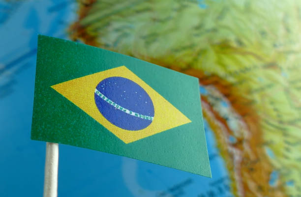 istock Brazilian flag with a globe map as a background macro 641562760