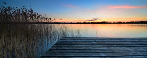 istock Wooden Dock on Calm Lake at Sunset 641564188