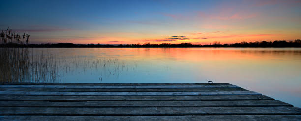 istock Wooden Dock on Calm Lake at Sunset 641564194