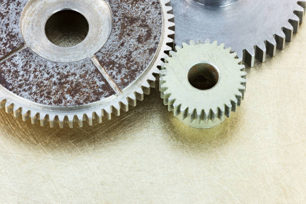 istock old metal gears on scratched brass background 641565248