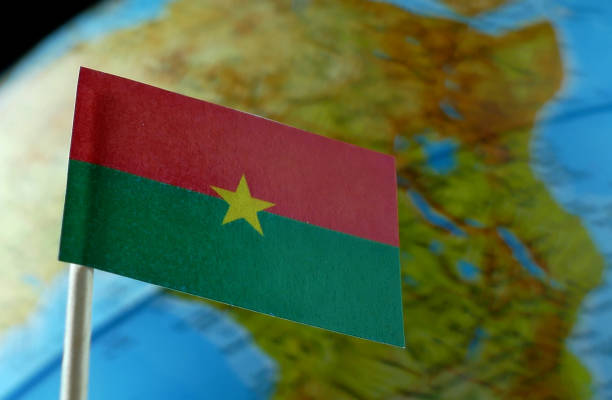 Burkina Faso flag with a globe map as a background macro