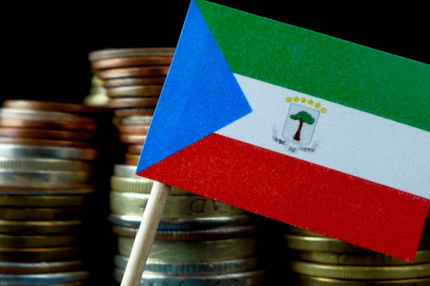 istock Equatorial Guinea flag waving with stack of money coins macro 641566264