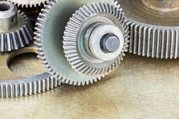 istock metal gears and cogwheels on scratched brass background 641568142