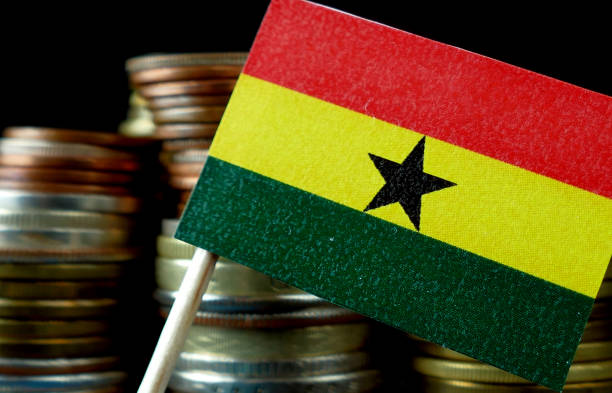 istock Ghana flag waving with stack of money coins macro 641569106