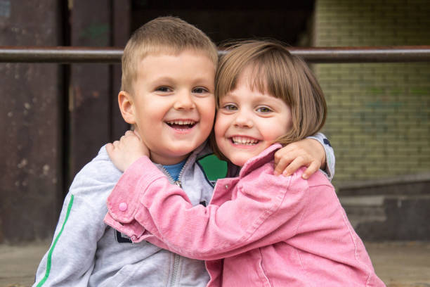 istock brother and sister are  hugging 641570288