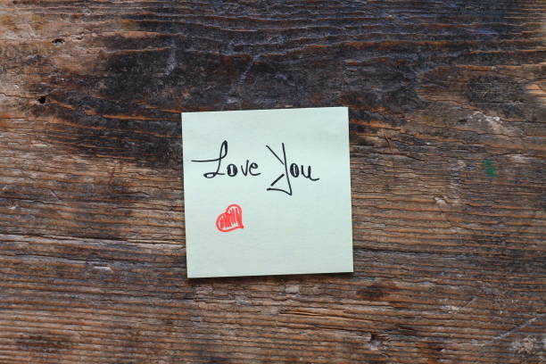 istock Message Love You with small red heart on wooden table 641571748