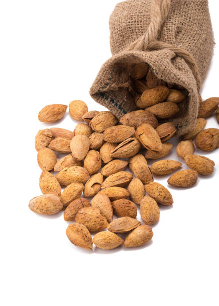 istock almonds in bag isolated on white background. 641573126