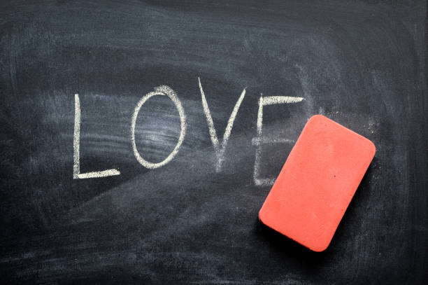 istock erasing love, hand written word on blackboard being erased concept 641574460