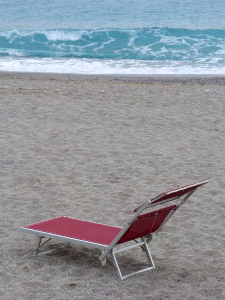 istock Red sunbed on sandy beach facing the clear sea 641576040